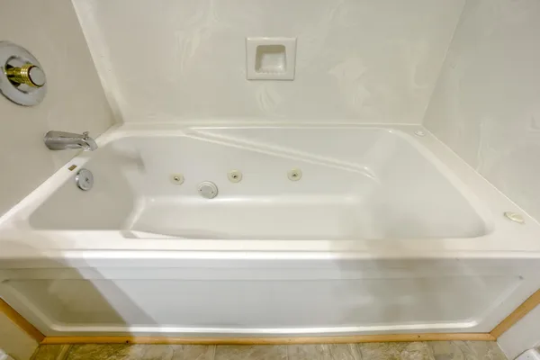 a bathroom with a toilet and a glass shower door