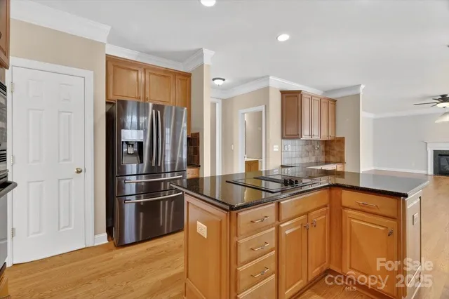 a kitchen with stainless steel appliances granite countertop a refrigerator and a sink
