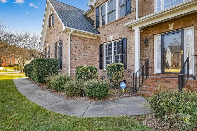 a view of a brick house with a yard