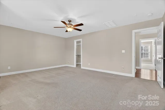 an empty room with closet and windows
