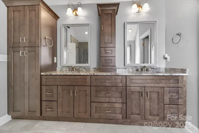 a spacious bathroom with a granite countertop sink mirror and a