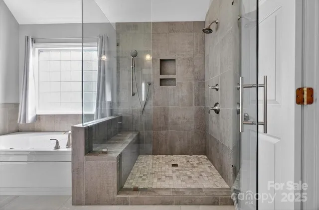 a spacious bathroom with a shower and a sink