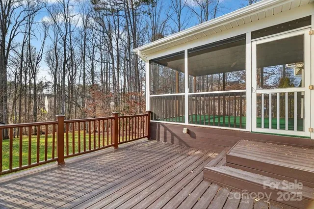 a view of balcony with wooden floor and fence
