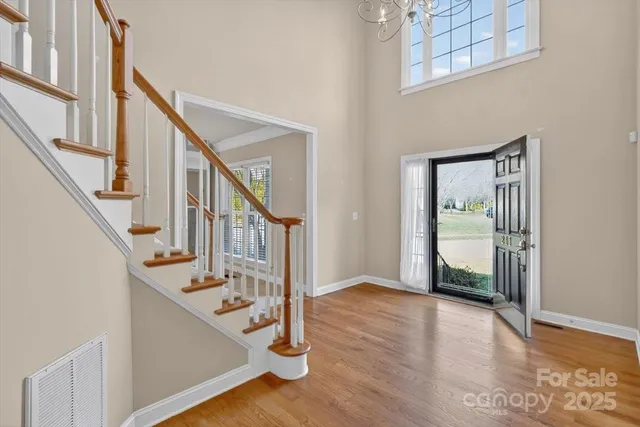 a view of an entryway with wooden floor and staircase