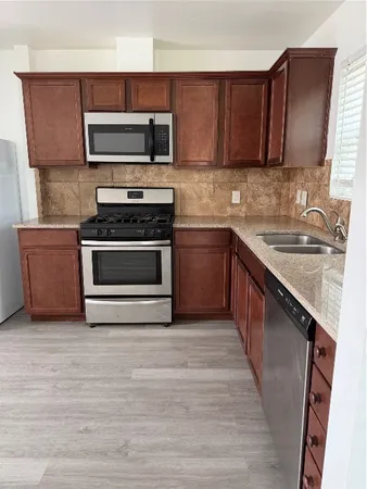 a kitchen with a sink stove and microwave