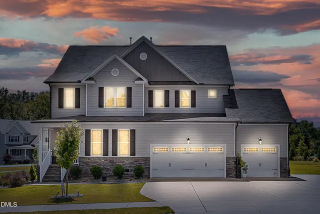 a front view of a house with a yard and garage