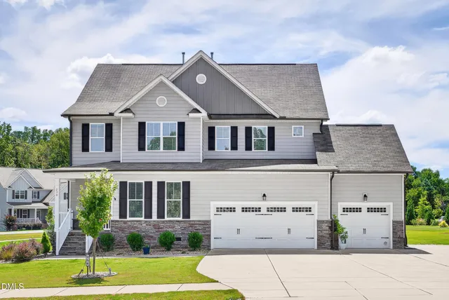 a front view of a house with a yard and garage