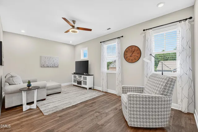 a living room with furniture a window and a flat screen tv