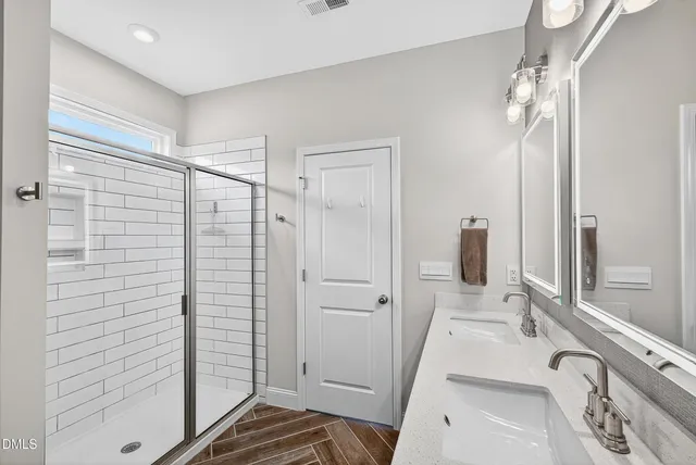 a bathroom with a sink and shower