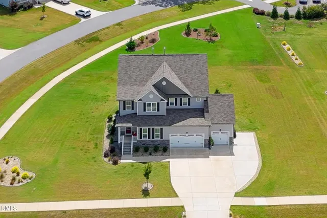 an aerial view of a house with a swimming pool