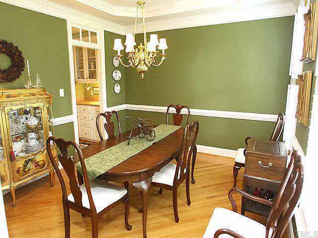 9113 Reedham Oaks Court Raleigh, NC 27615 - Photo 3 of 10 Ample dining room connected to kitchen by butlers pantry/china storage. Beautiful hardwoods have decorative cross-directional bordering. Also plantation shutters run throughout the house, even the garage!