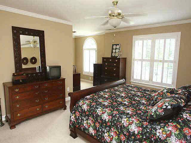9113 Reedham Oaks Court Raleigh, NC 27615 - Photo 7 of 10 The master suite has a wonderful sitting area that can serve as a reading alcove or office. The master bath has vaulted ceiling with skylights, walk-in closet, dual vanities and luxurious whirpool bath with large sep shower. Bright and sparkling!