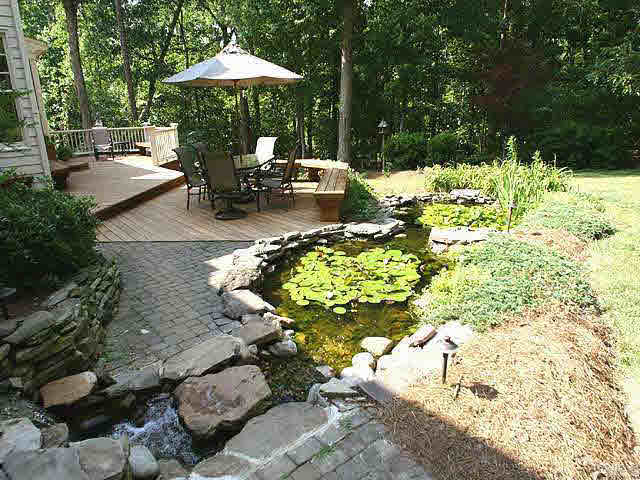 9113 Reedham Oaks Court Raleigh, NC 27615 - Photo 8 of 10 One of the prettiest backyard environments around! Your screenporch leads to multi-tiered stained deck with bench seating and is embraced by flowing water feature with two ponds surrounded by rocks. So tranquil.