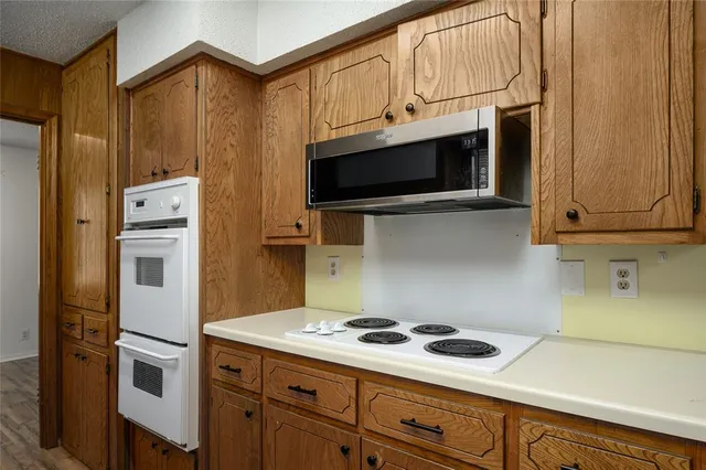 a kitchen with stainless steel appliances a stove a microwave and cabinets