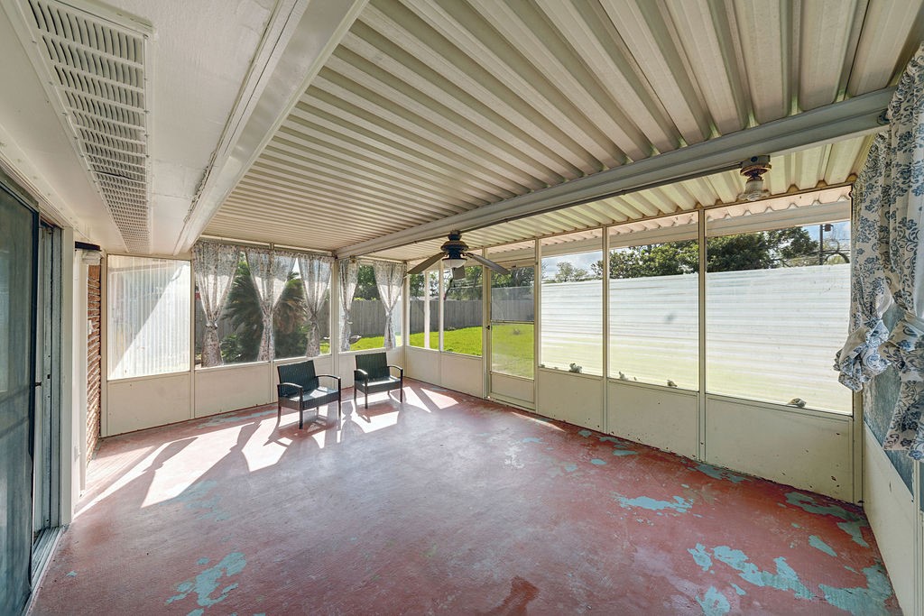 614 Gilpin Street Houston, TX 77034 - Photo 19 of 27 Enjoy serene moments in a cozy screened porch with views of a spacious, fenced yard perfect for relaxation and play.