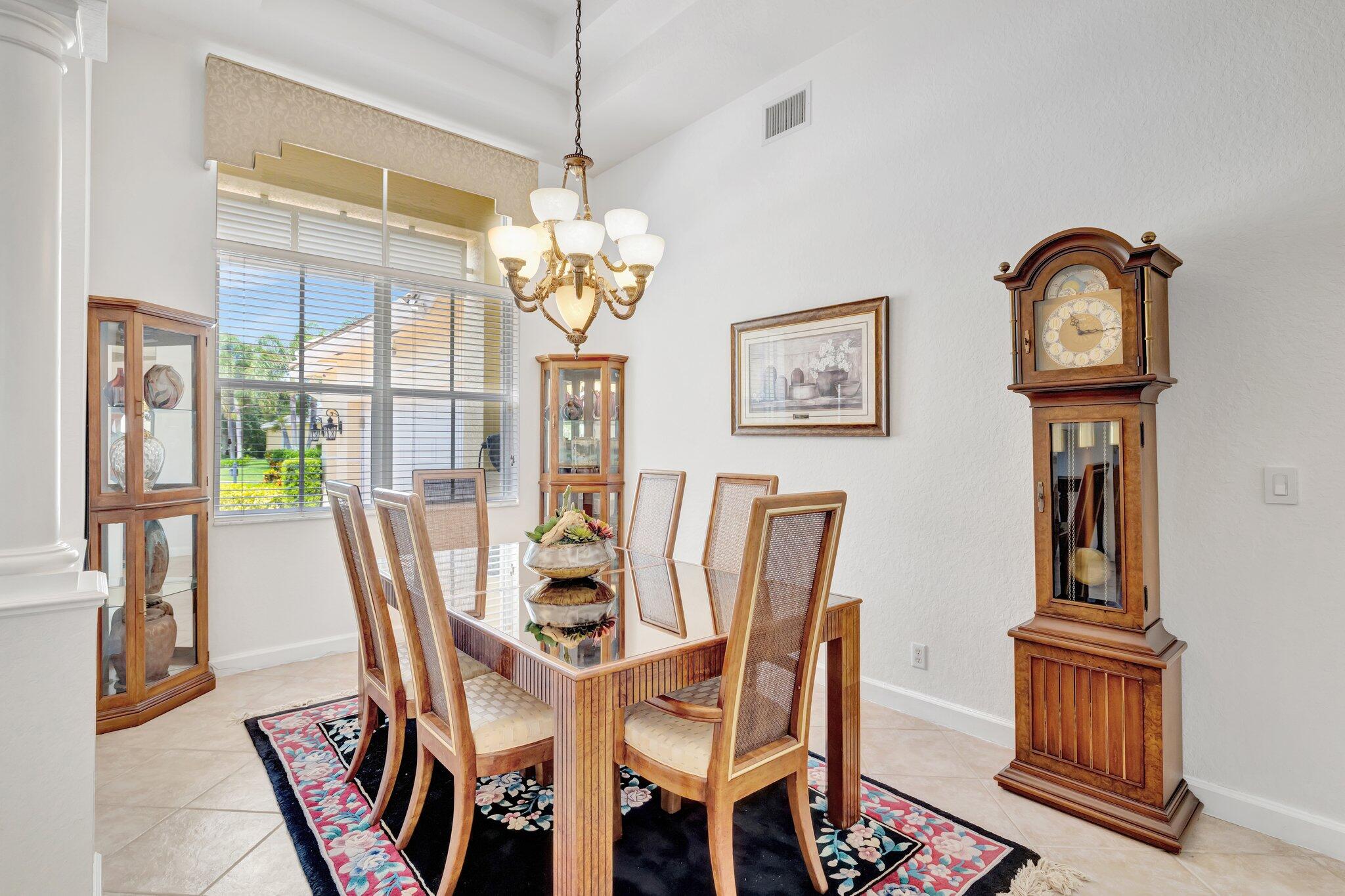 699 Southwest River Bend Circle Stuart, FL 34997 - Photo 12 of 78 a view of a dining room with furniture wooden floor and chandelier