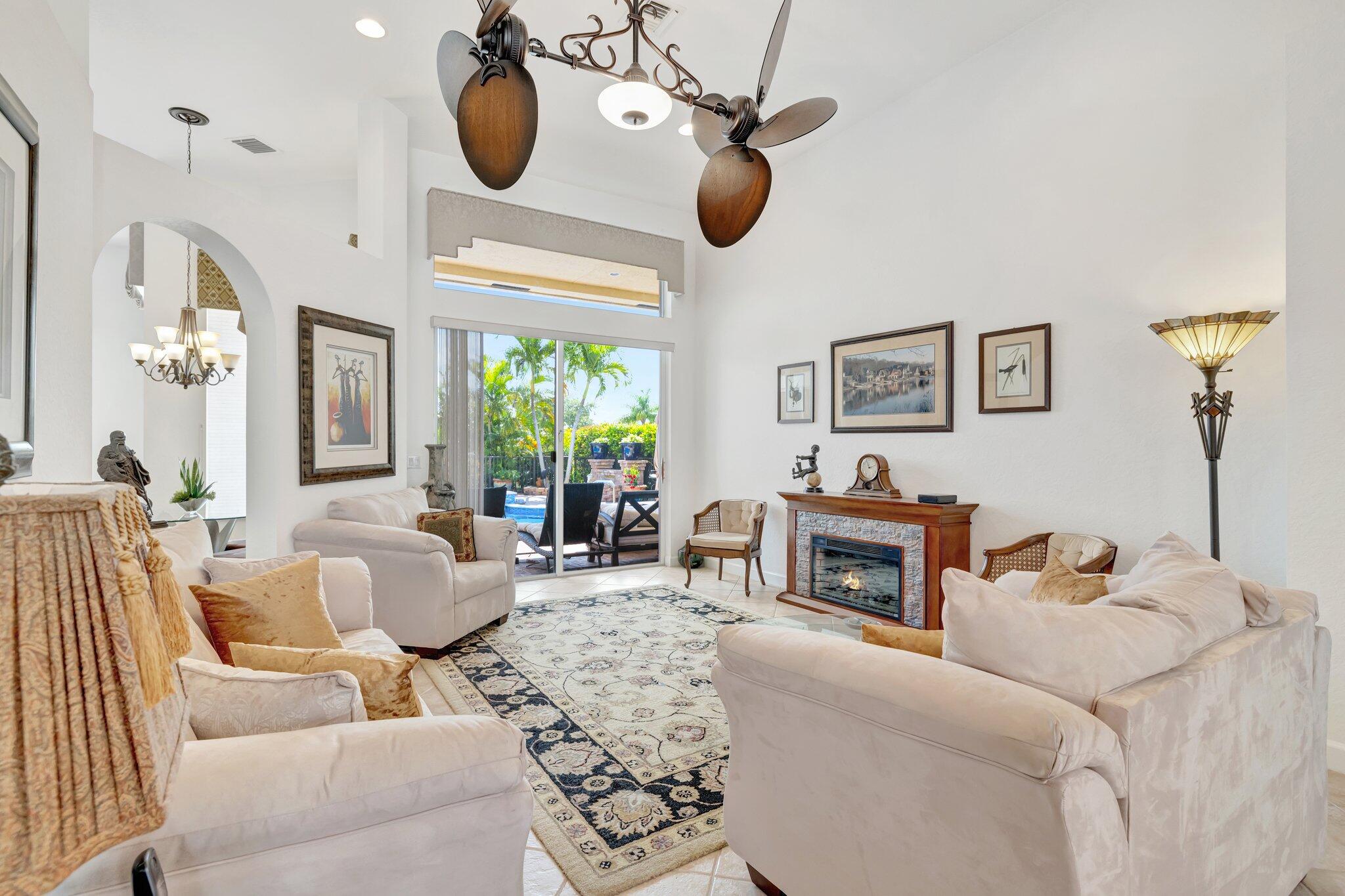 699 Southwest River Bend Circle Stuart, FL 34997 - Photo 14 of 78 a living room with furniture and a fireplace