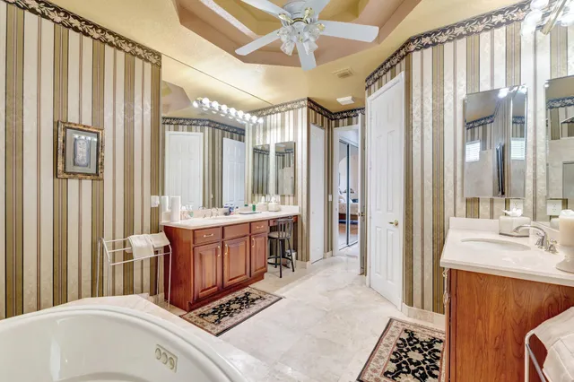 a bathroom with a sink toilet vanity and shower