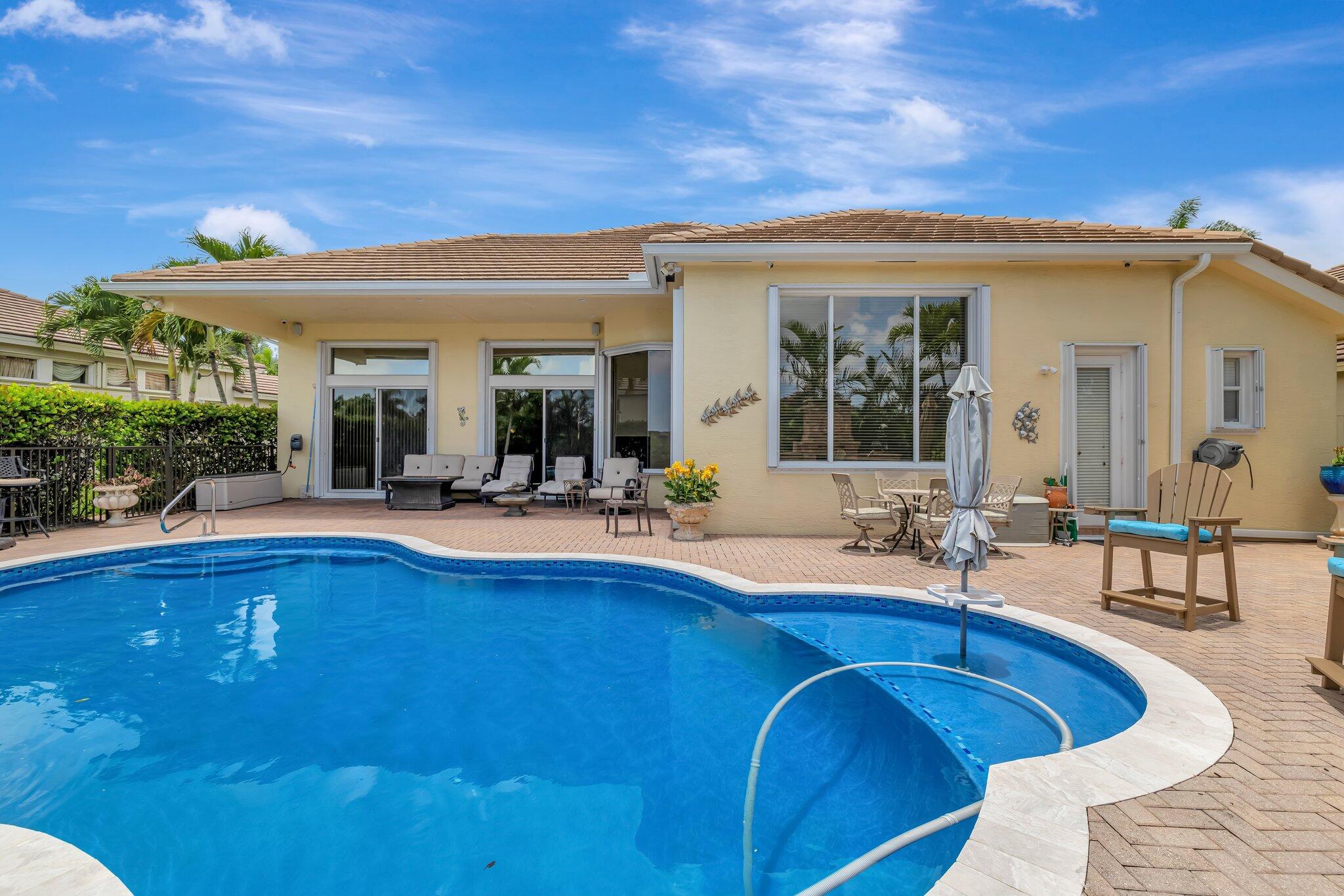 699 Southwest River Bend Circle Stuart, FL 34997 - Photo 28 of 78 a view of a house with swimming pool and sitting area
