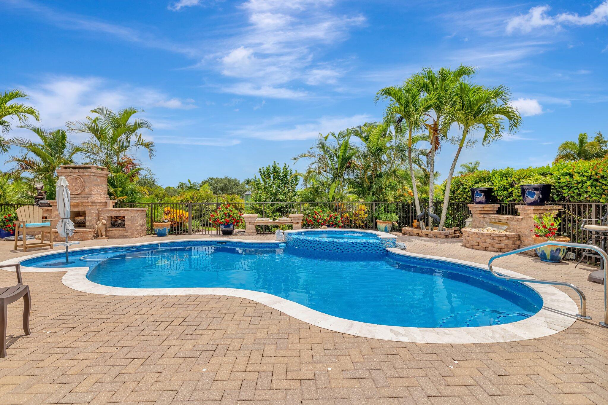 699 Southwest River Bend Circle Stuart, FL 34997 - Photo 32 of 78 a view of a swimming pool with a lounge chair