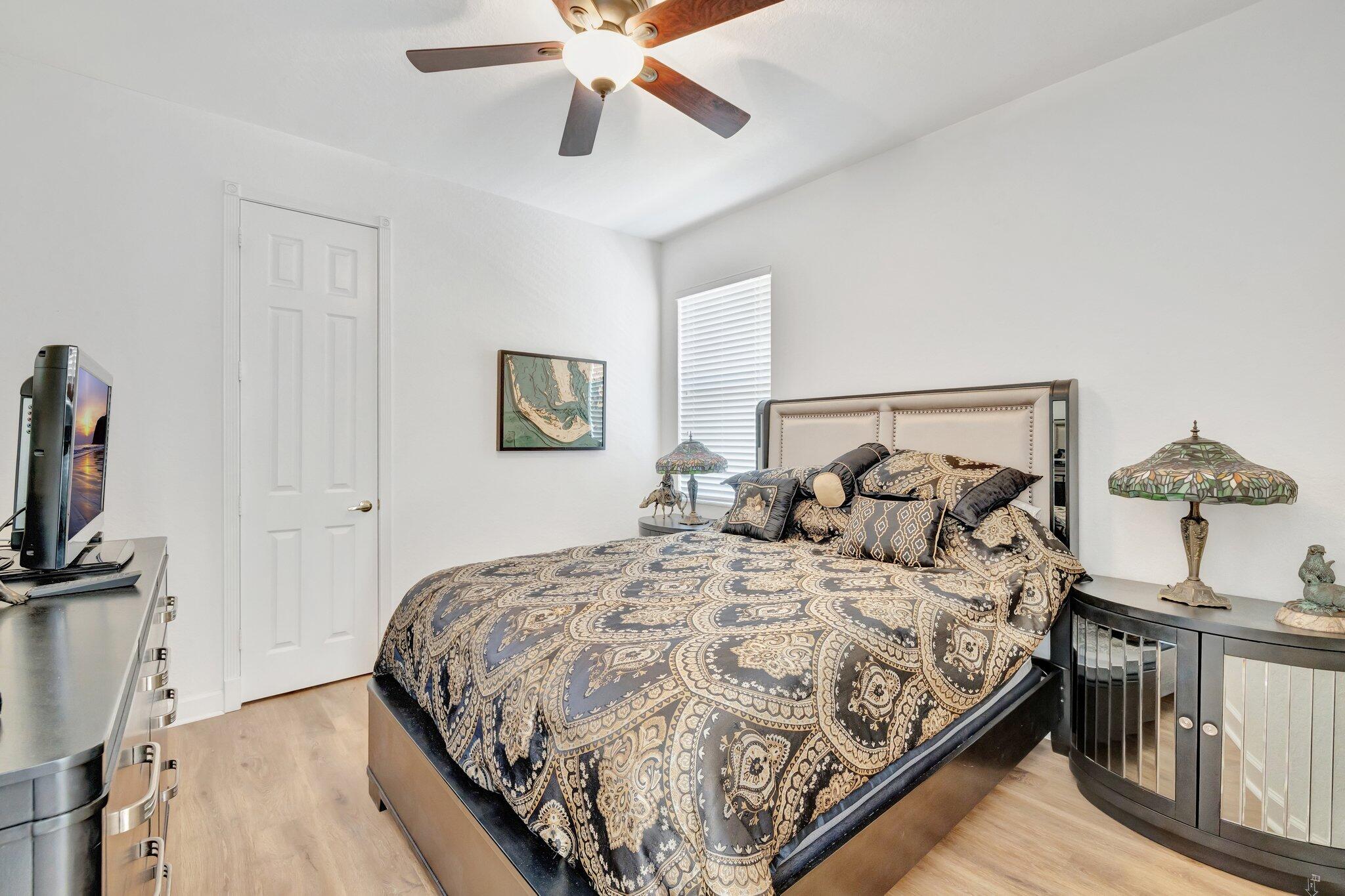 699 Southwest River Bend Circle Stuart, FL 34997 - Photo 38 of 78 a bedroom with a bed and a flat tv screen on the dresser
