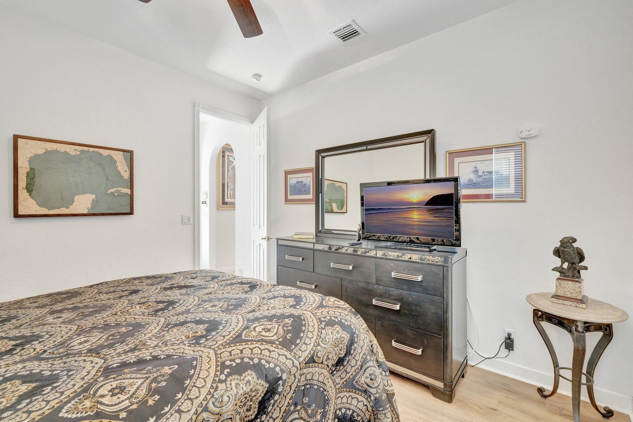 699 Southwest River Bend Circle Stuart, FL 34997 - Photo 39 of 78 a bedroom with a bed and a flat screen tv