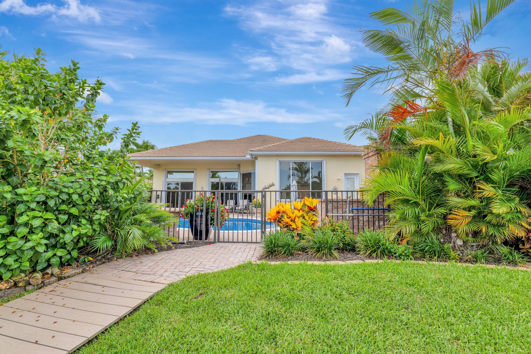 699 Southwest River Bend Circle Stuart, FL 34997 - Photo 52 of 78 a front view of house with yard and outdoor seating
