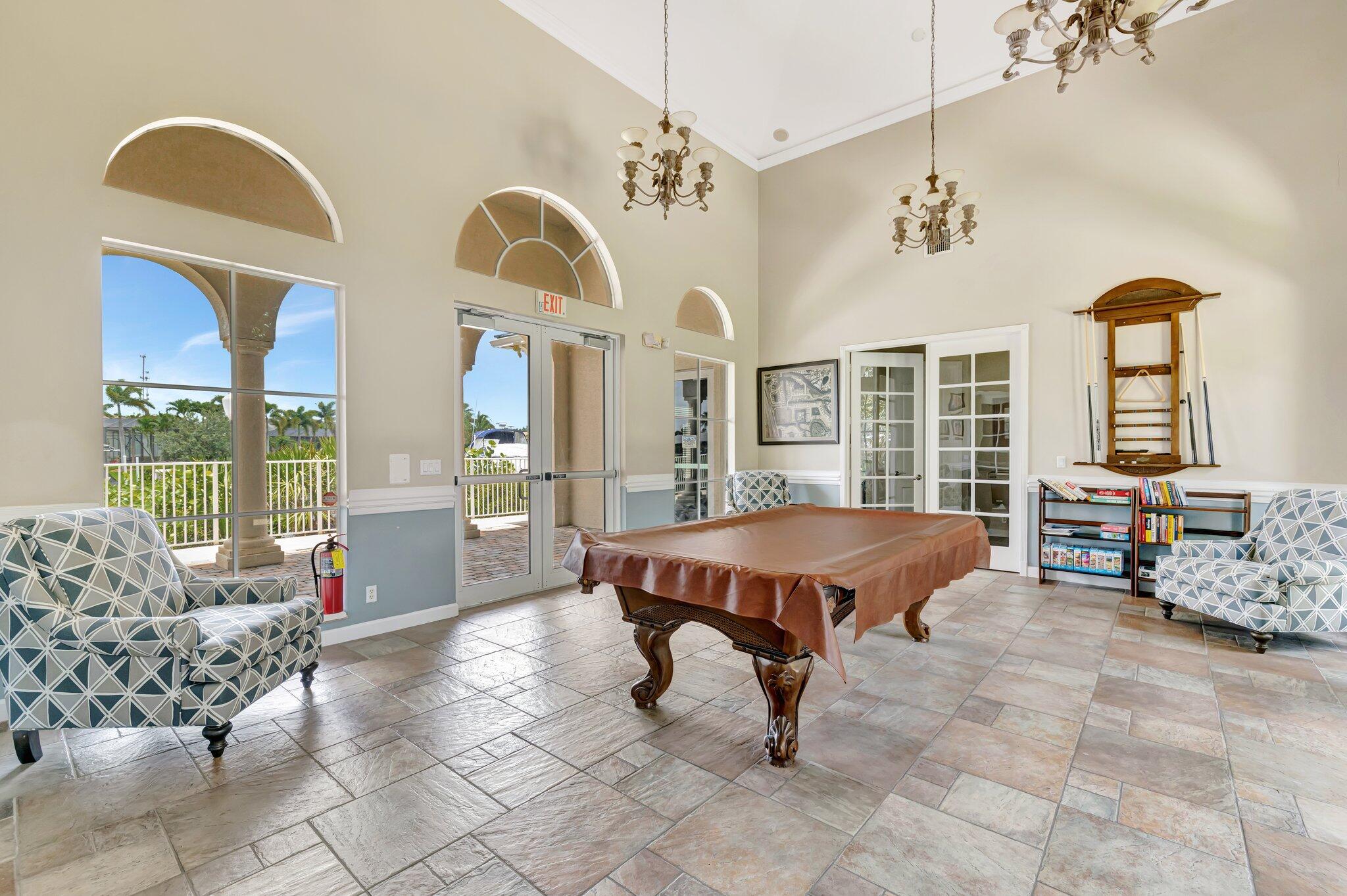 699 Southwest River Bend Circle Stuart, FL 34997 - Photo 55 of 78 a living room with furniture pool table and a large window