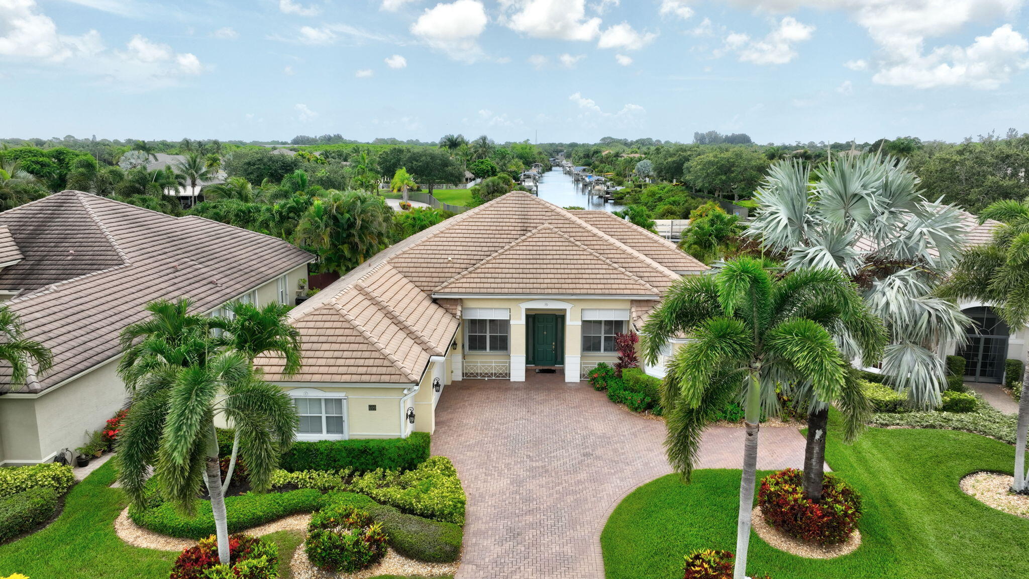 699 Southwest River Bend Circle Stuart, FL 34997 - Photo 61 of 78 a front view of a house with a garden and plants