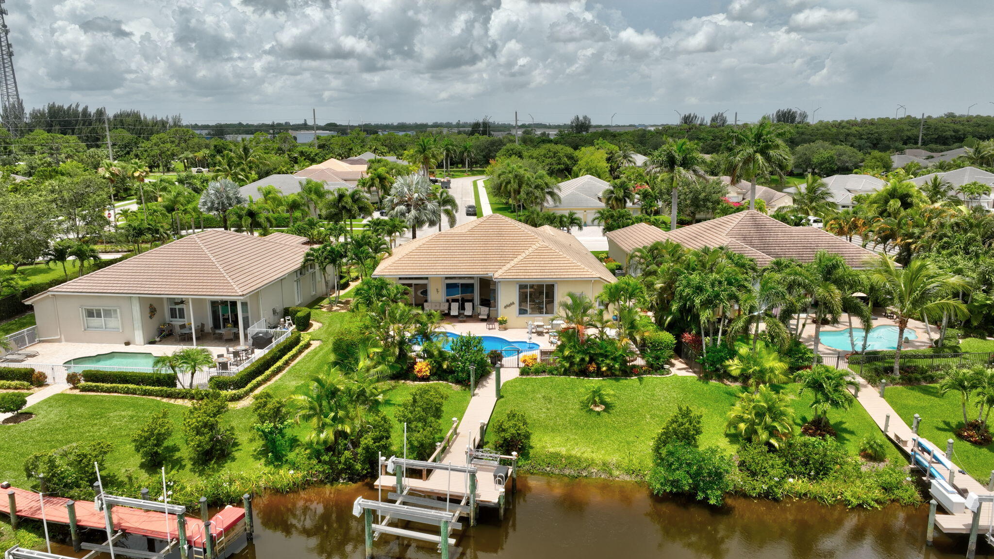 699 Southwest River Bend Circle Stuart, FL 34997 - Photo 70 of 78 an aerial view of a house with yard swimming pool outdoor seating yard and mountain view