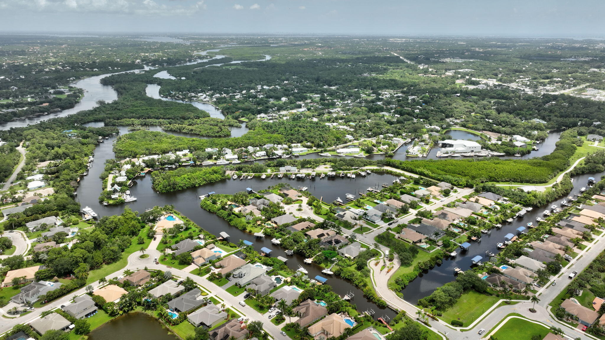 699 Southwest River Bend Circle Stuart, FL 34997 - Photo 73 of 78 an aerial view of residential houses with outdoor space and trees