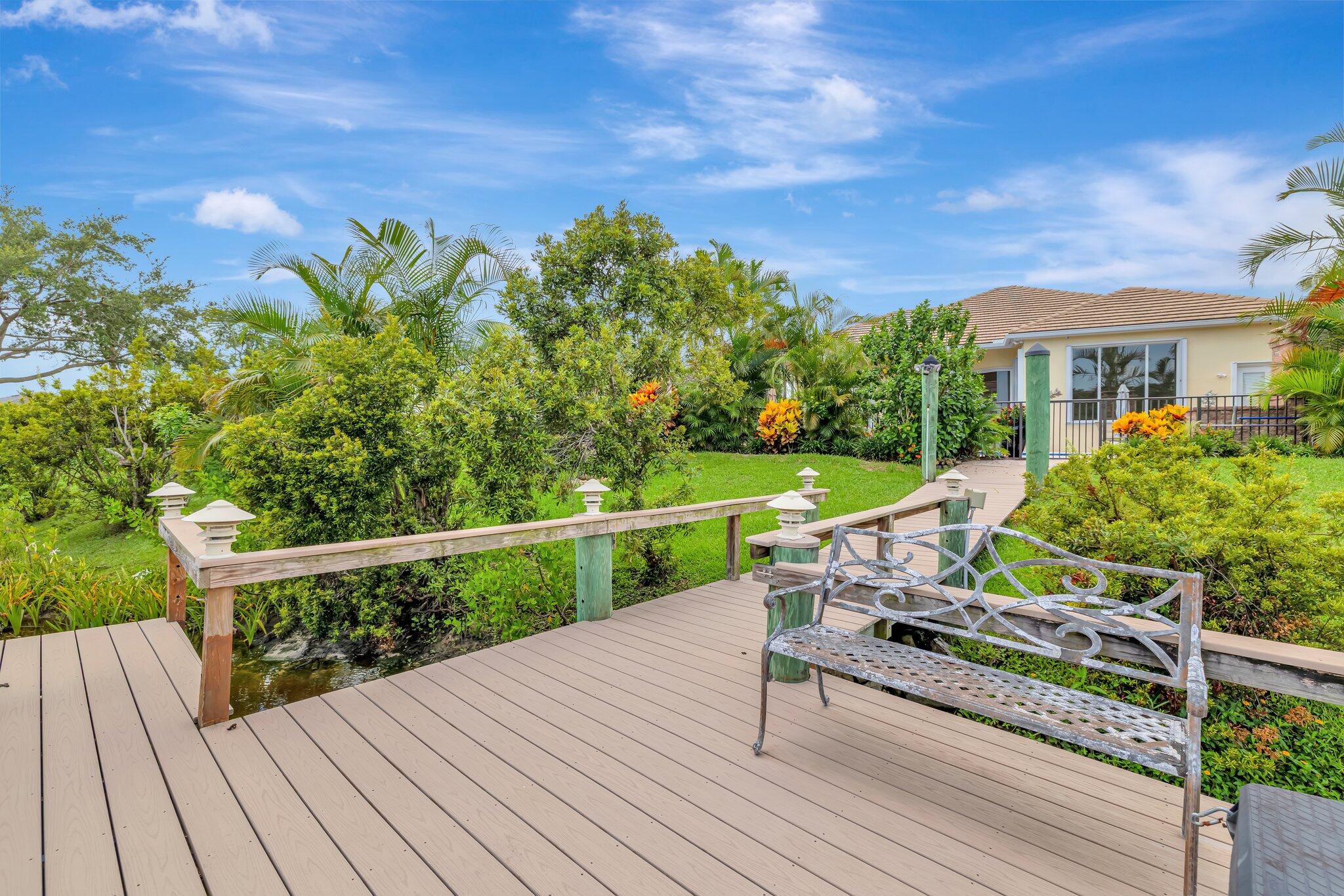 699 Southwest River Bend Circle Stuart, FL 34997 - Photo 9 of 78 a view of a roof deck with wooden floor and fence