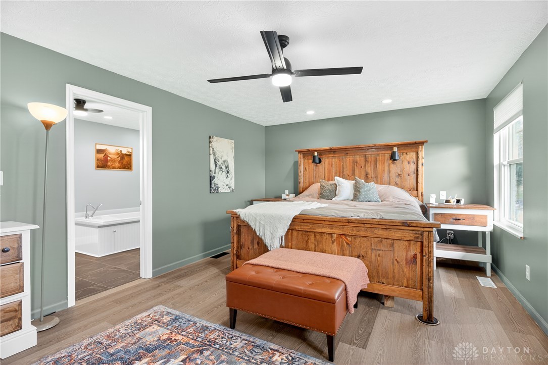 7888 Darke-Preble County Line Road Arcanum, OH 45304 - Photo 26 of 51 This spacious primary bedroom features durable flooring and convenient access to an en-suite bathroom.