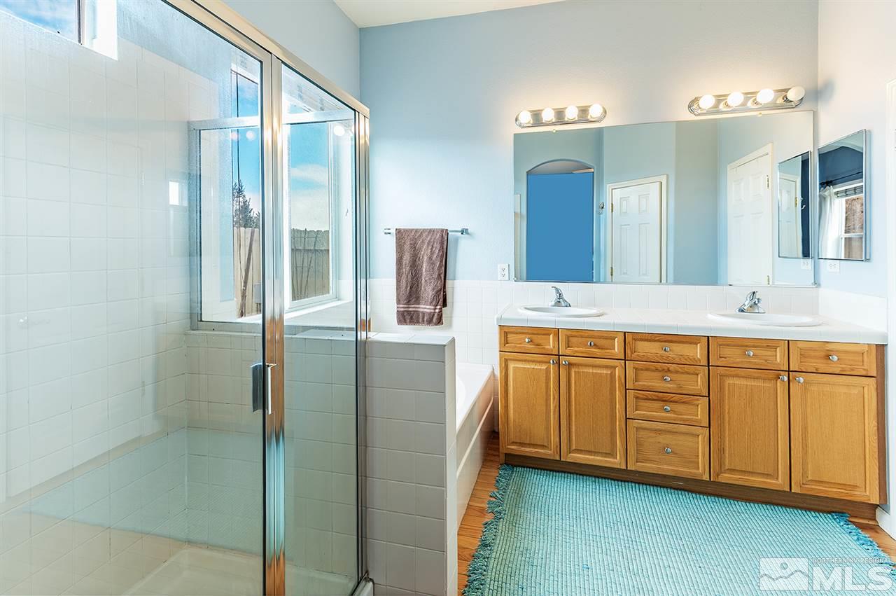 10535 Arbor Way Reno, NV 89521 - Photo 14 of 19 a spacious bathroom with a double vanity sink a mirror and shower
