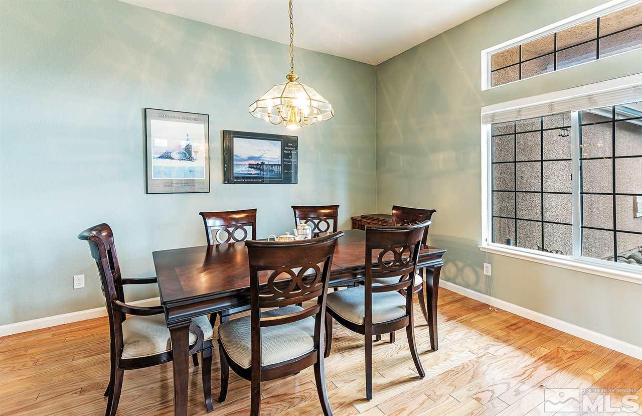10535 Arbor Way Reno, NV 89521 - Photo 6 of 19 a view of a dining room with furniture a chandelier and wooden floor