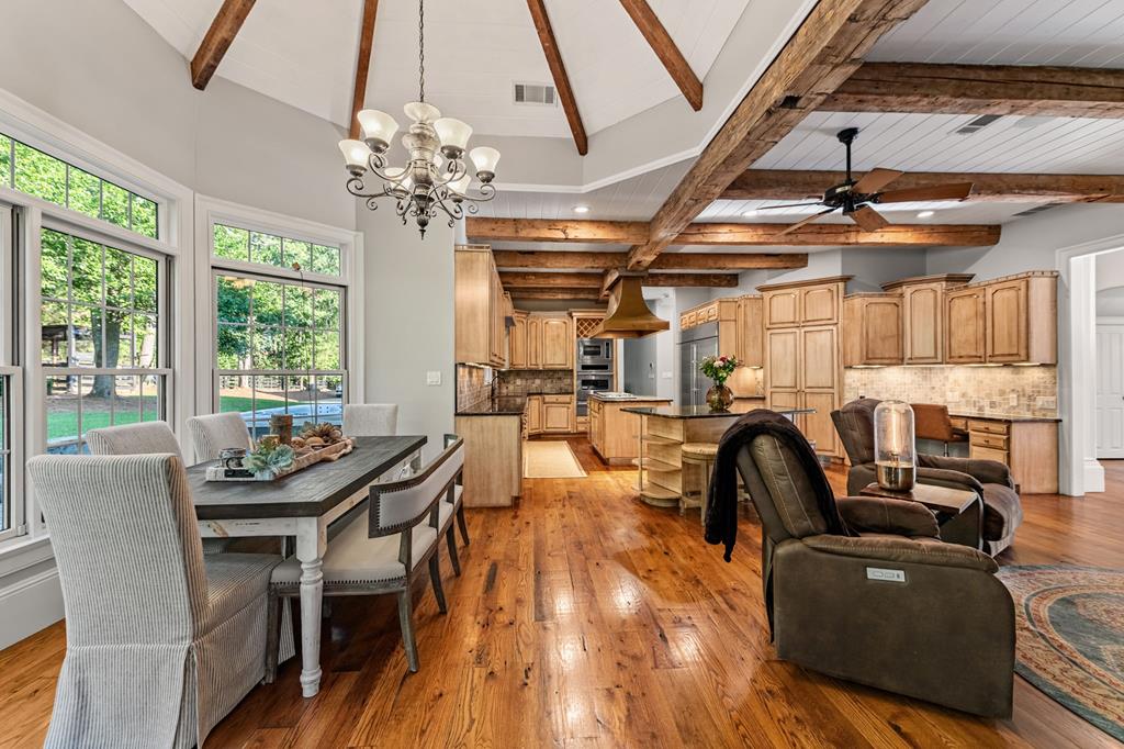 640 A J Land Road Canton, GA 30115 - Photo 21 of 94 a dining room with furniture a chandelier and wooden floor