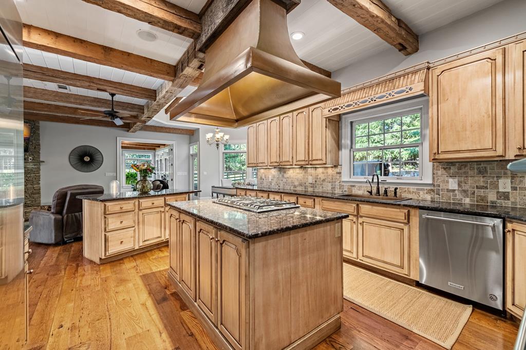 640 A J Land Road Canton, GA 30115 - Photo 25 of 94 a kitchen with stainless steel appliances granite countertop a stove a sink dishwasher and white cabinets with wooden floor