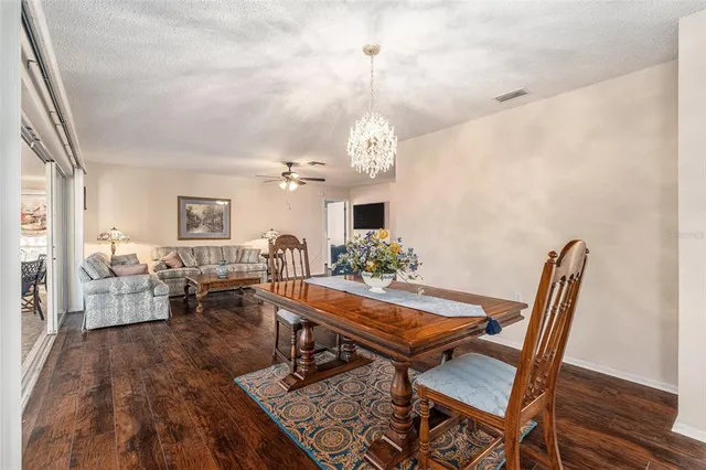 a dining room with furniture a rug and wooden floor
