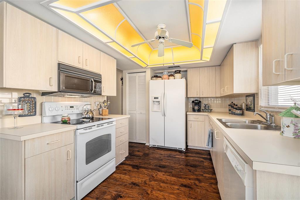4636 Portland Manor Drive New Port Richey, FL 34655 - Photo 13 of 37 a kitchen with a stove a sink and a refrigerator