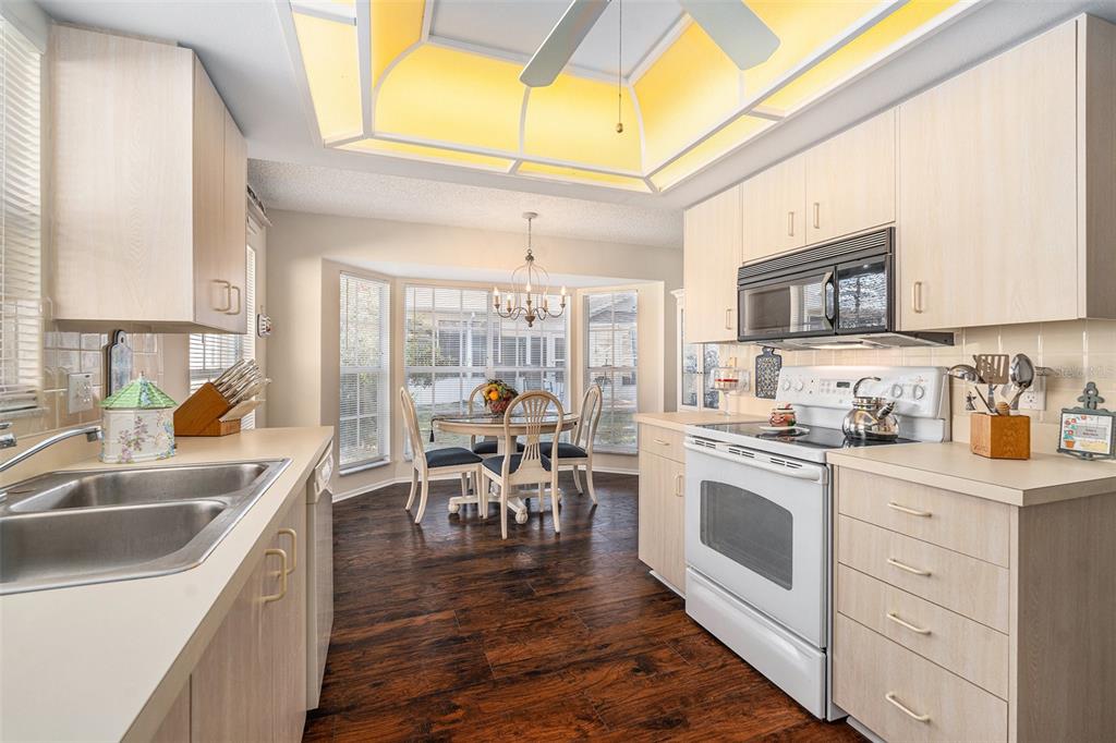 4636 Portland Manor Drive New Port Richey, FL 34655 - Photo 14 of 37 a kitchen with stainless steel appliances granite countertop a stove a sink and a microwave