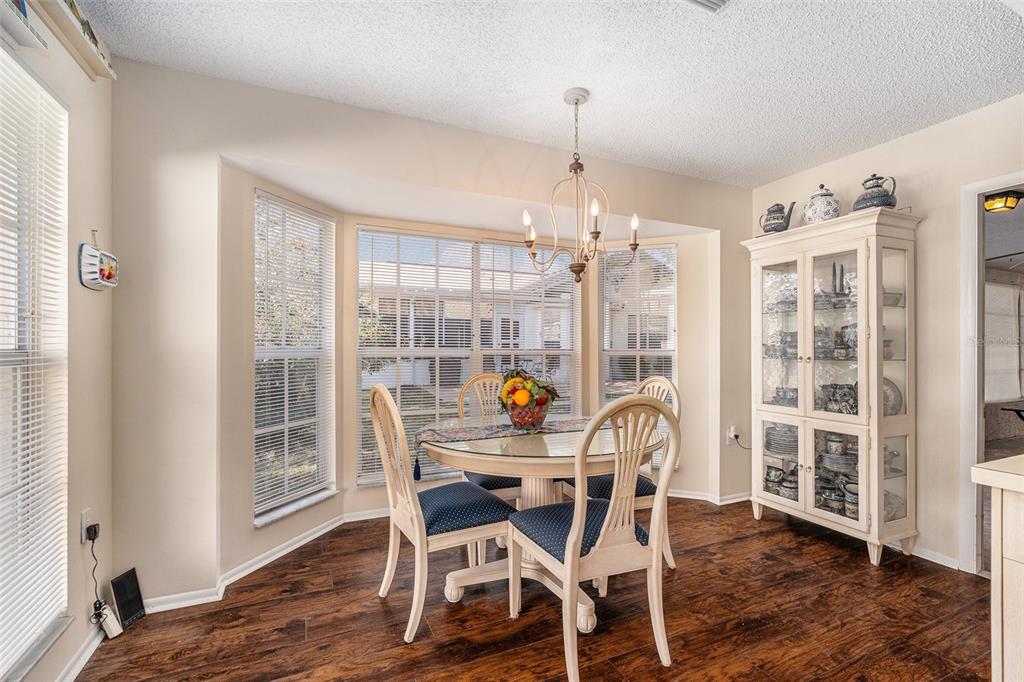 4636 Portland Manor Drive New Port Richey, FL 34655 - Photo 15 of 37 a view of a dining room with furniture wooden floor and chandelier