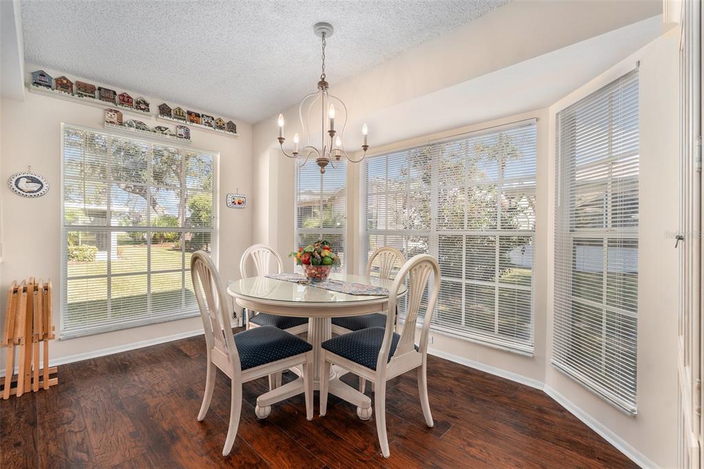 4636 Portland Manor Drive New Port Richey, FL 34655 - Photo 16 of 37 a view of a dining room with furniture window and wooden floor