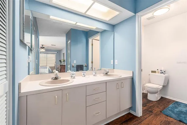 a bathroom with a toilet a sink and a mirror