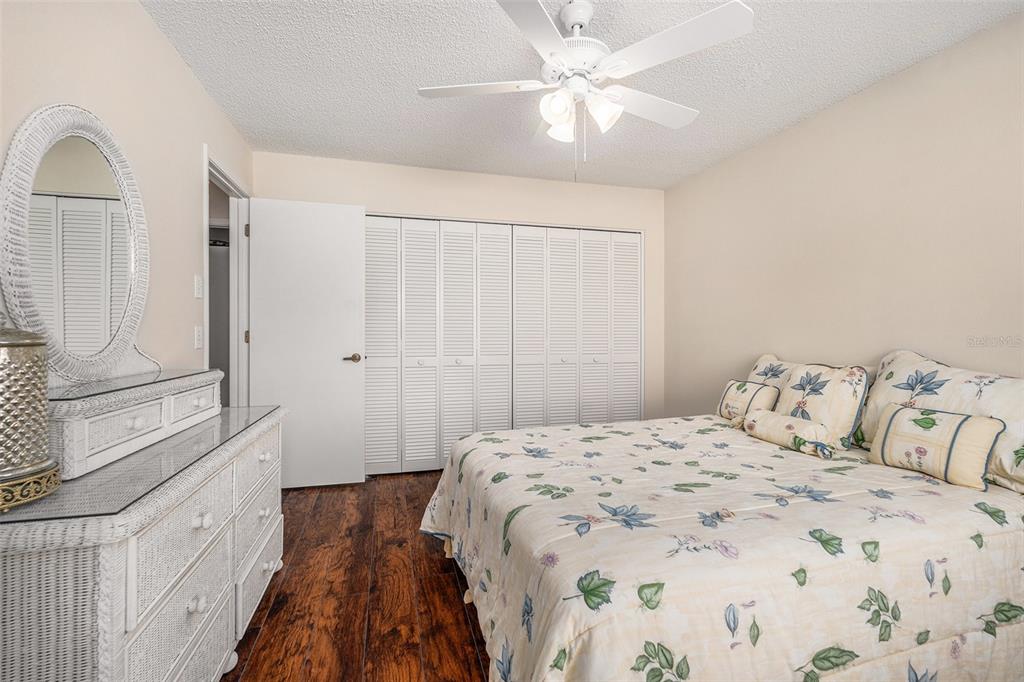 4636 Portland Manor Drive New Port Richey, FL 34655 - Photo 24 of 37 a bedroom with a large bed and a chandelier