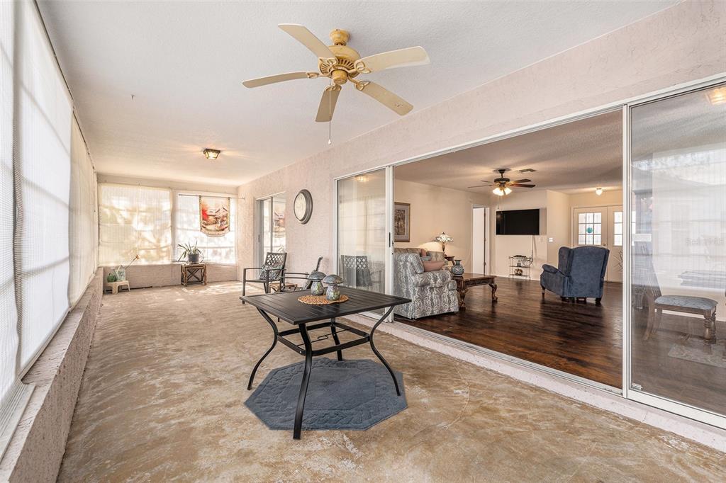 4636 Portland Manor Drive New Port Richey, FL 34655 - Photo 27 of 37 a living room with furniture a table and chairs