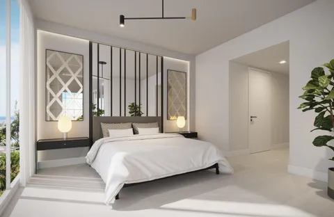 a bedroom with a large bed and a potted plant