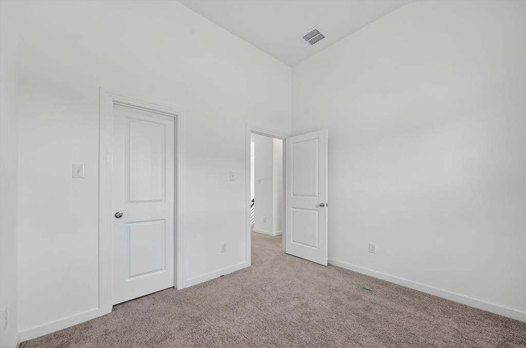 1153 Queensdown Way Forney, TX 75126 - Photo 16 of 26 Interior room featuring light gray carpet, white walls, and white trim