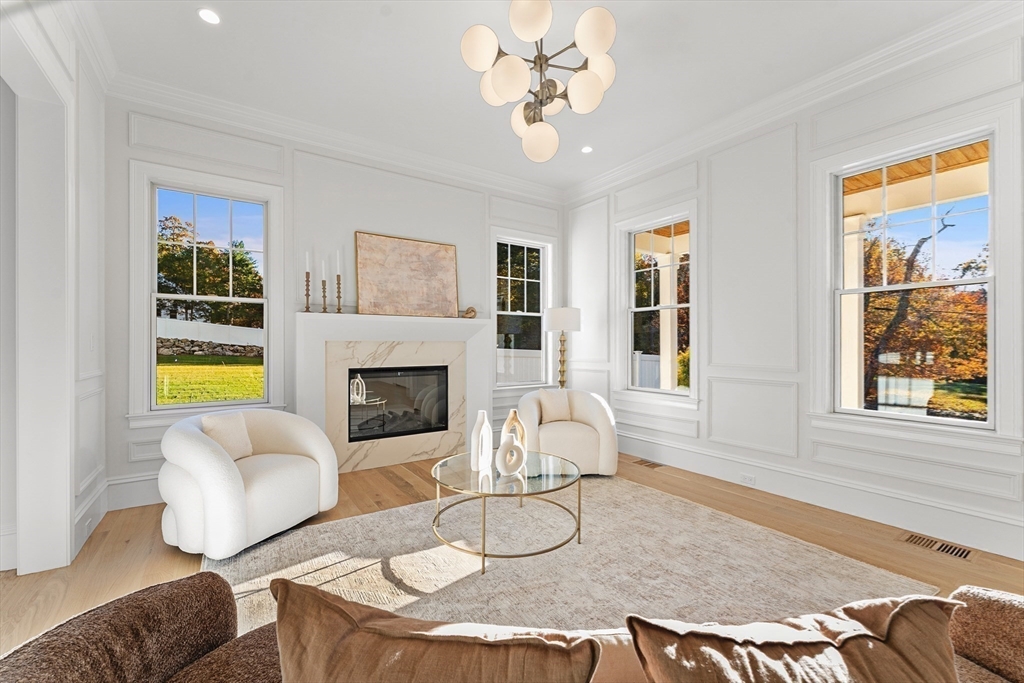1266 South Street Needham, MA 02492 - Photo 15 of 32 a living room with furniture a fireplace and a table