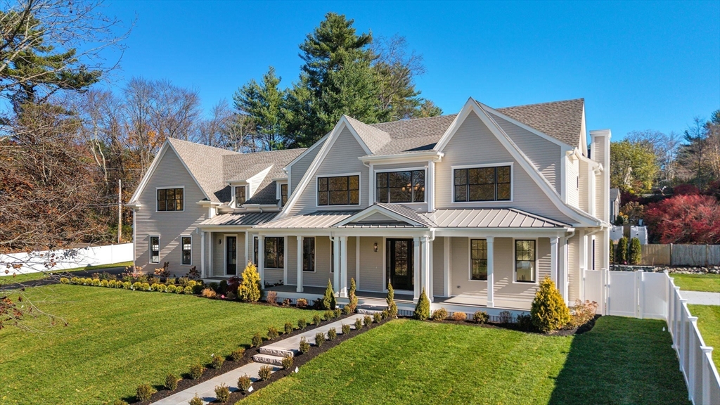 1266 South Street Needham, MA 02492 - Photo 2 of 32 a front view of a house with a yard table and chairs