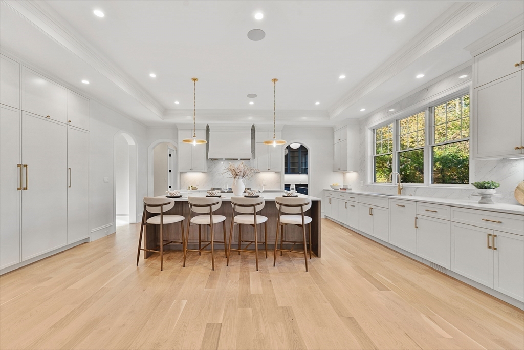1266 South Street Needham, MA 02492 - Photo 8 of 32 a large kitchen with lots of furniture a sink appliances and a dining table